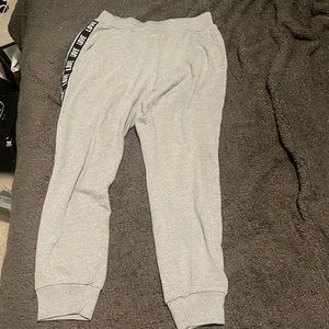 Grey sweatpants with labeled stripe on the side with the word ‘LOVE’